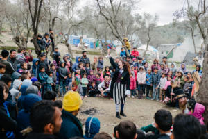 Clowns entertaining kids in the middle of Moria camp.